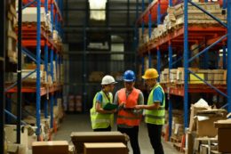 Team of workers collaborating to solve warehousing issue